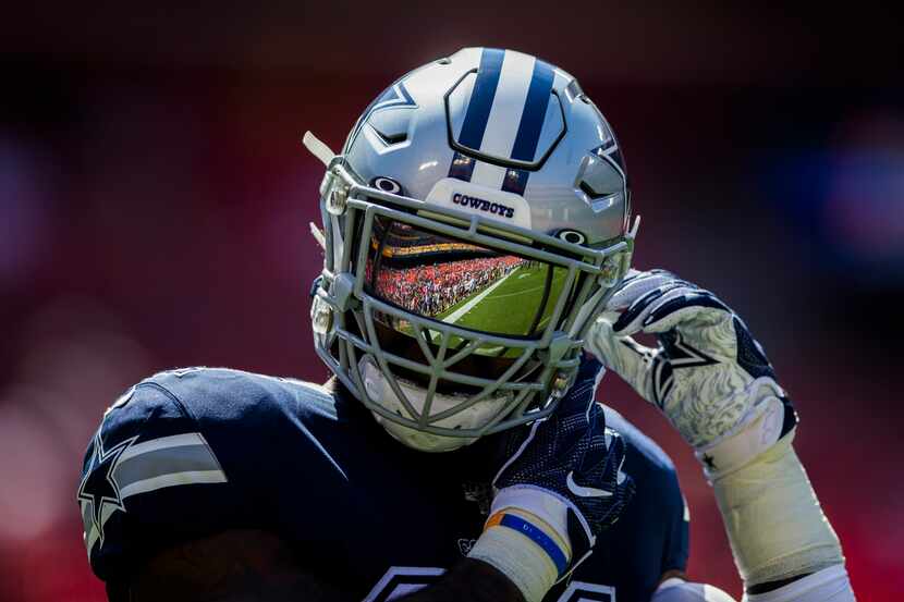 Dallas Cowboys running back Ezekiel Elliott (21) has the field reflected in his helmet as he...