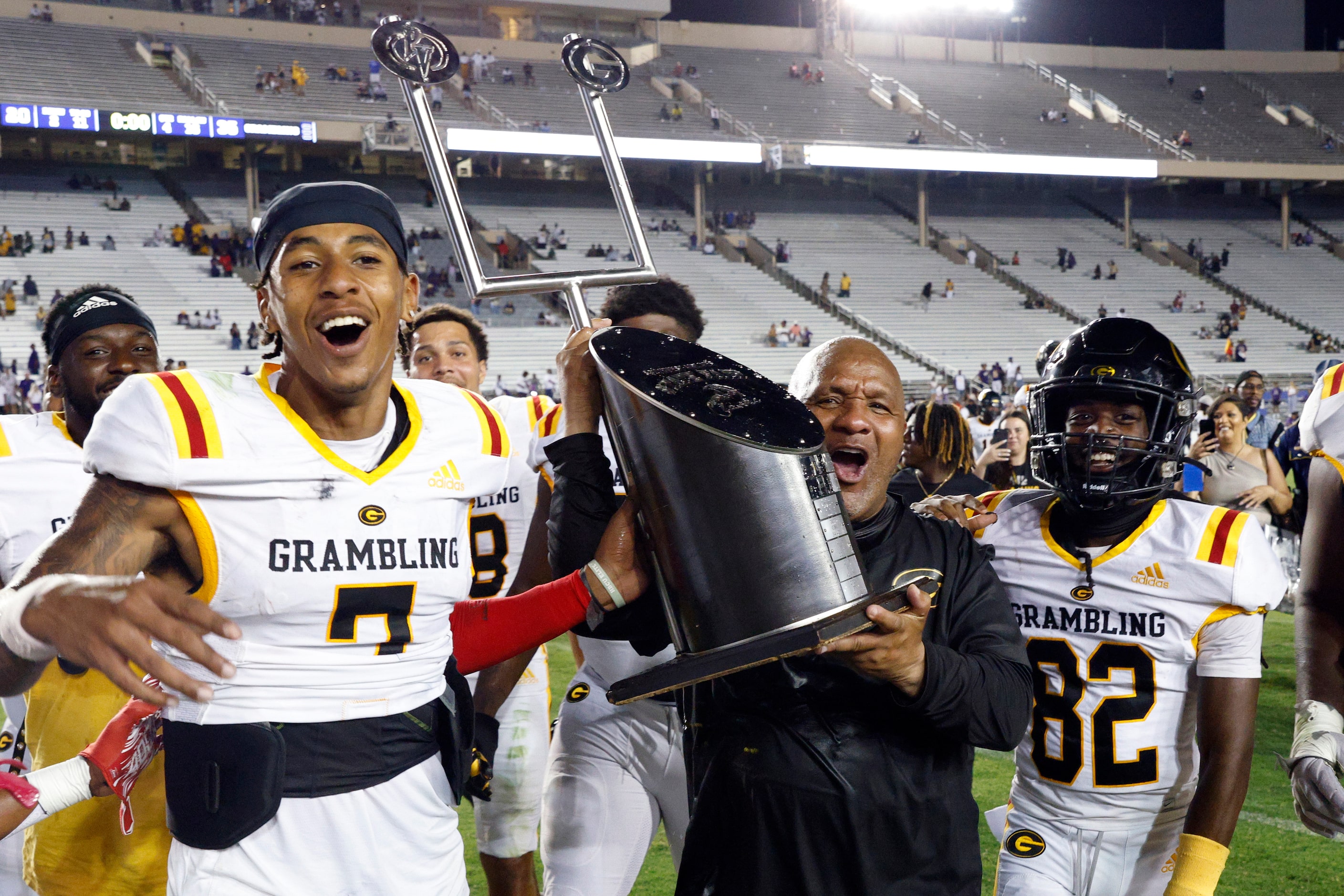 Grambling State head coach Hue Jackson carries the State Fair Classic trophy as he...