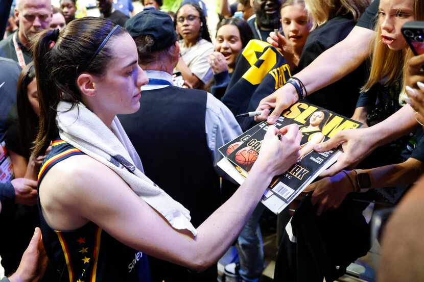 Indiana Fever guard Caitlin Clark gives autographs to her fans after a preseason WNBA...
