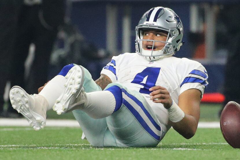 Dallas Cowboys quarterback Dak Prescott (4) looks up after scrambling for yardage in the...