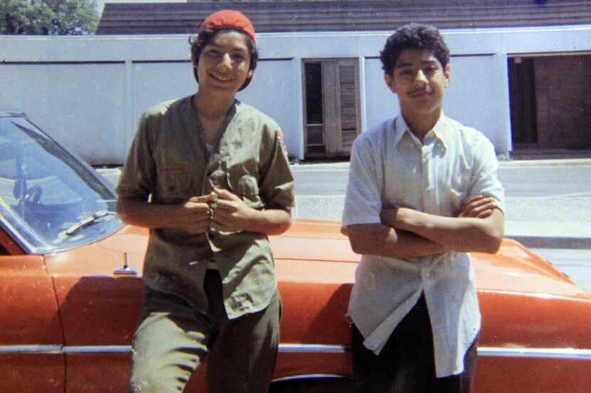 David Rodriguez, 13 (left), and his brother Santos Rodriguez, 12, stand by a relative's car...