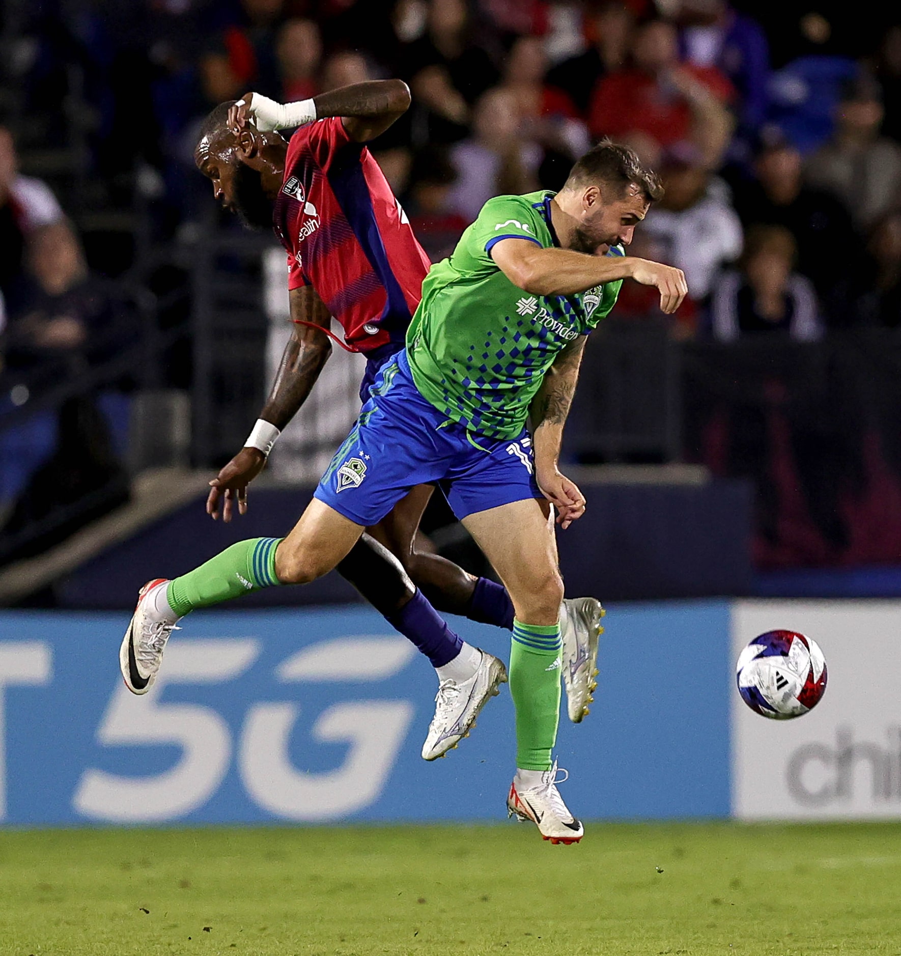 Seattle attacker Jordan Morris (right) and FC Dallas defender Sebastien Ibeagha (left) go...