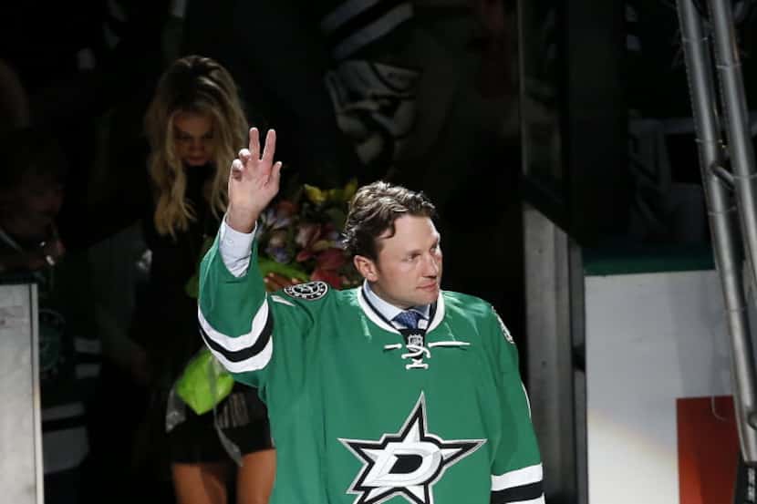 Former Dallas Stars player Brenden Morrow waves to the crowd in a retirement ceremony before...
