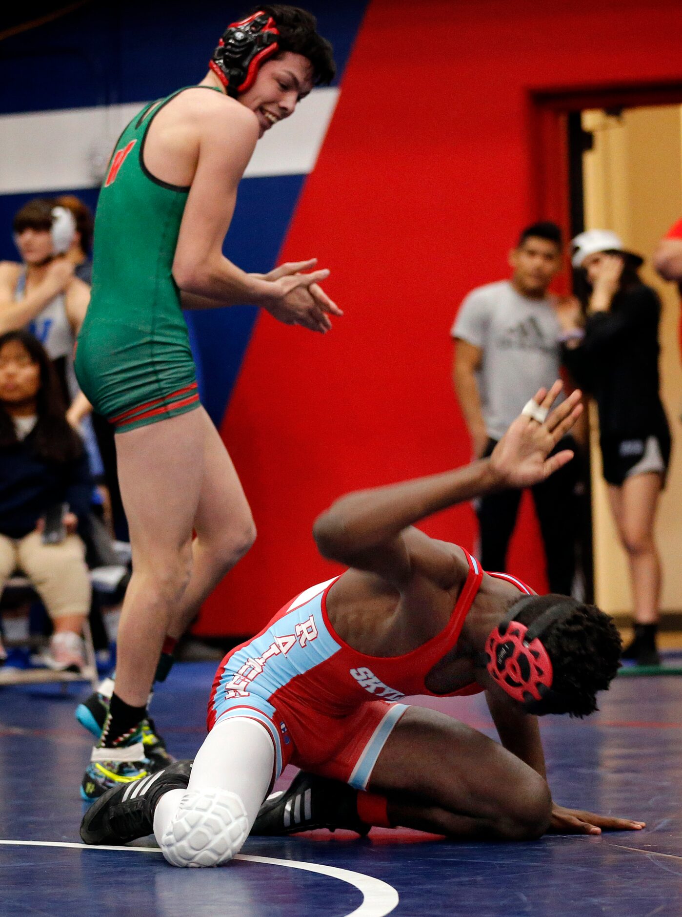 Dallas Skyline wrestler Ntamavukir Gasarabaga pounds his hand on the mat after losing the...