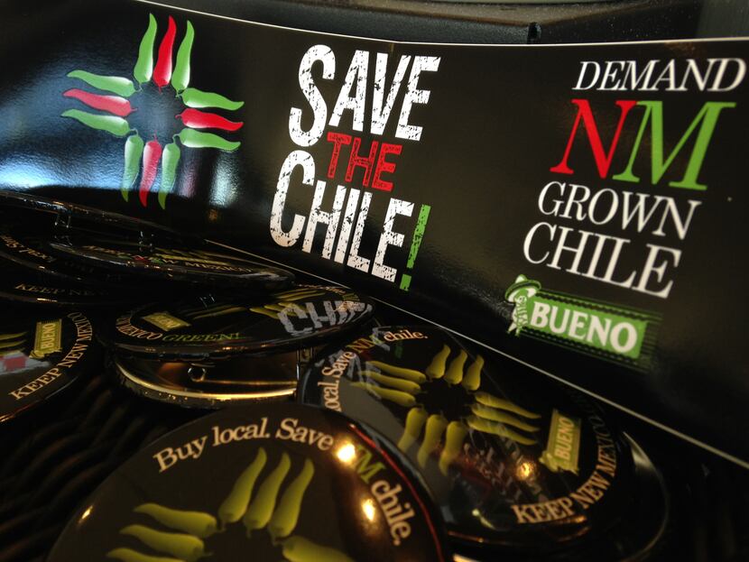 In this July 31, 2013 image, a collection of bumper stickers and buttons promoting New...