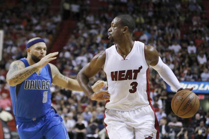Miami Heat guard Dwyane Wade (3) drives past Dallas Mavericks guard Deron Williams (8) in...