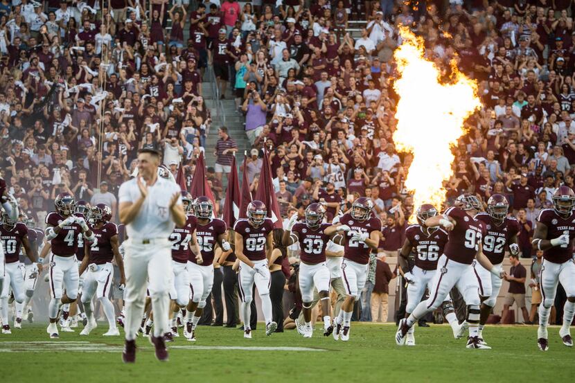 FILE - The Texas A&M Aggies burst onto the field prior to a matchup between the Texas A&M...
