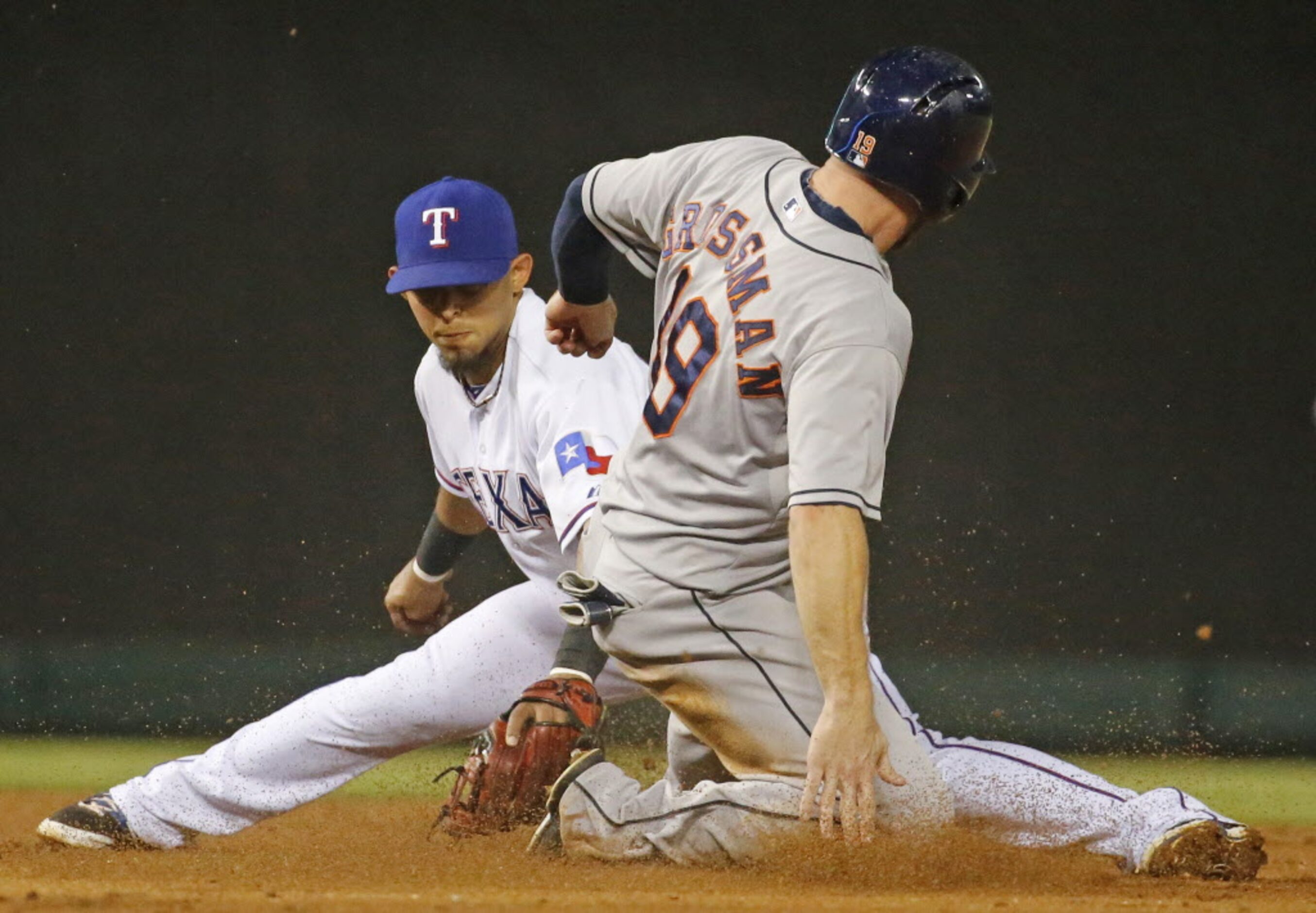 Houston's Robbie Grossman is safe at second on a steal as Texas second baseman Rougned Odor...