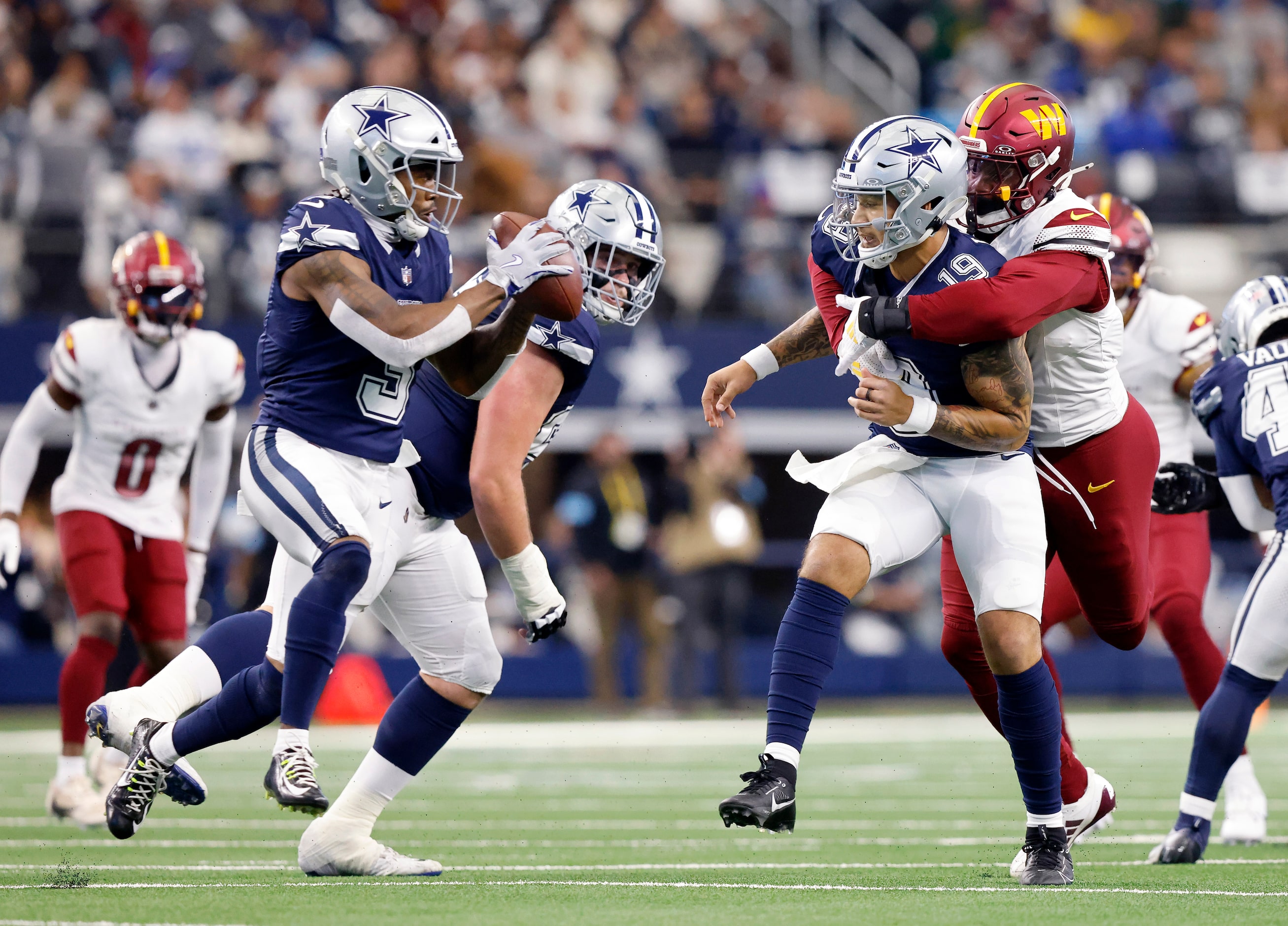 Dallas Cowboys wide receiver Brandin Cooks (3) takes a pitch as quarterback Trey Lance (19)...