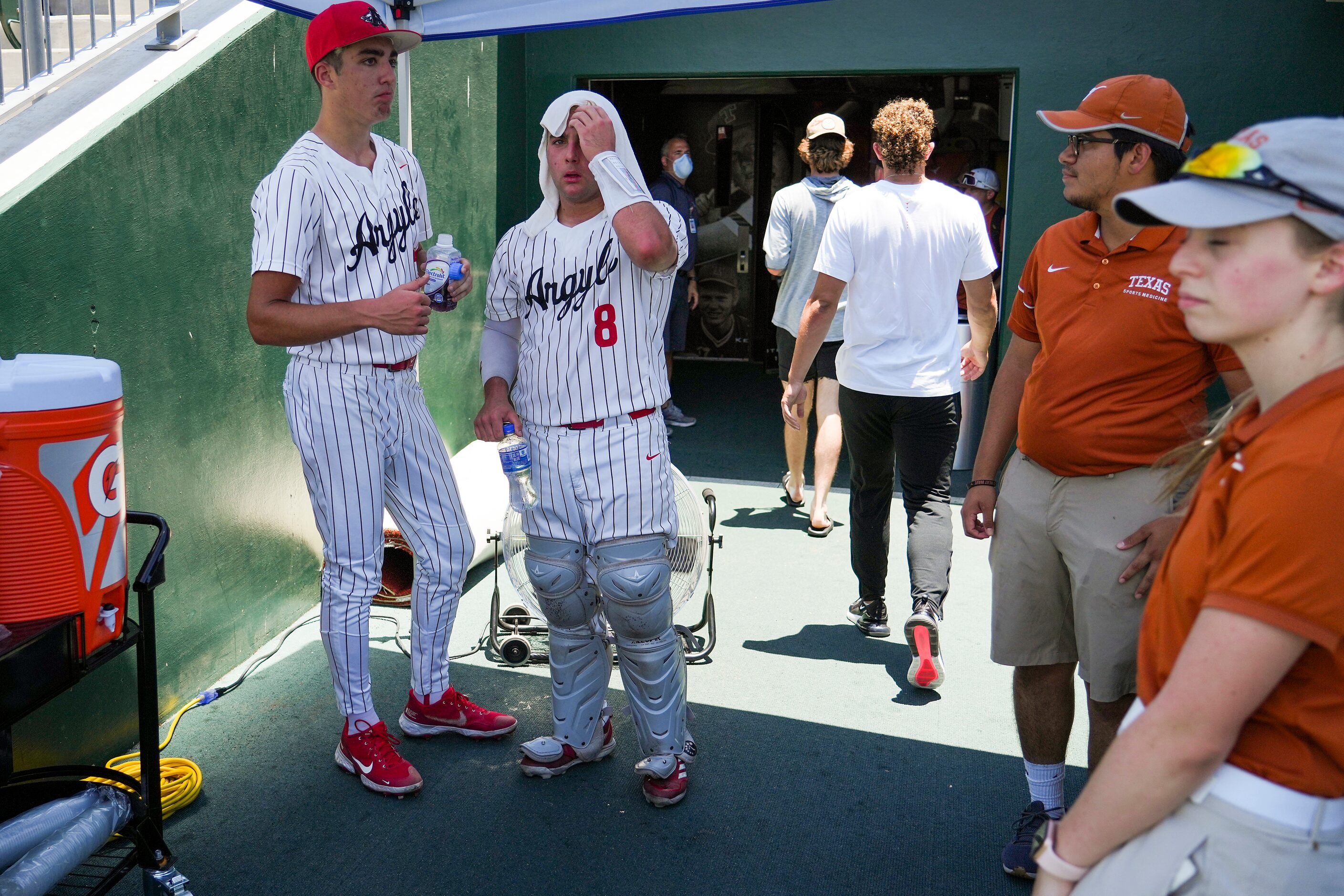 Argyle catcher Hunter Sandifer (8) and pitcher Evan Brandt (31) cool off between innings in...