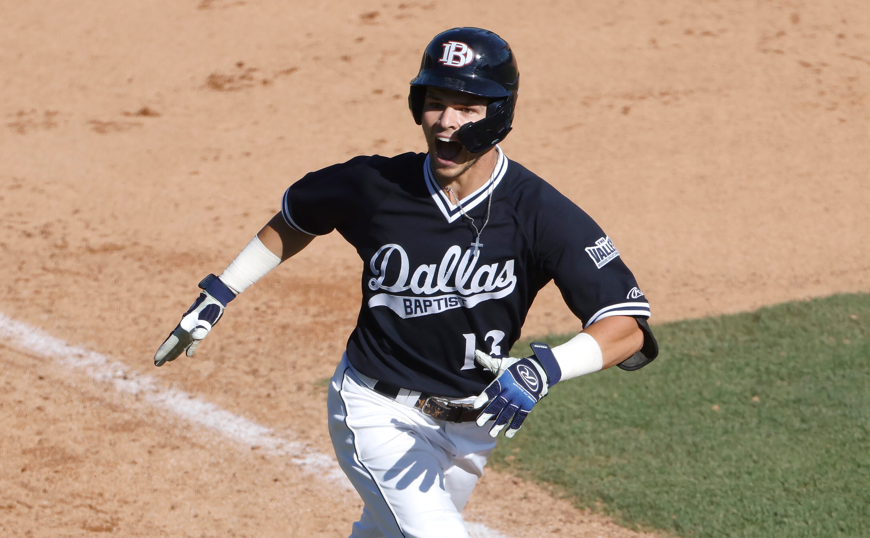 Dallas Baptist infielder Andrew Benefield (13) reacts after hitting a grand slam home run...