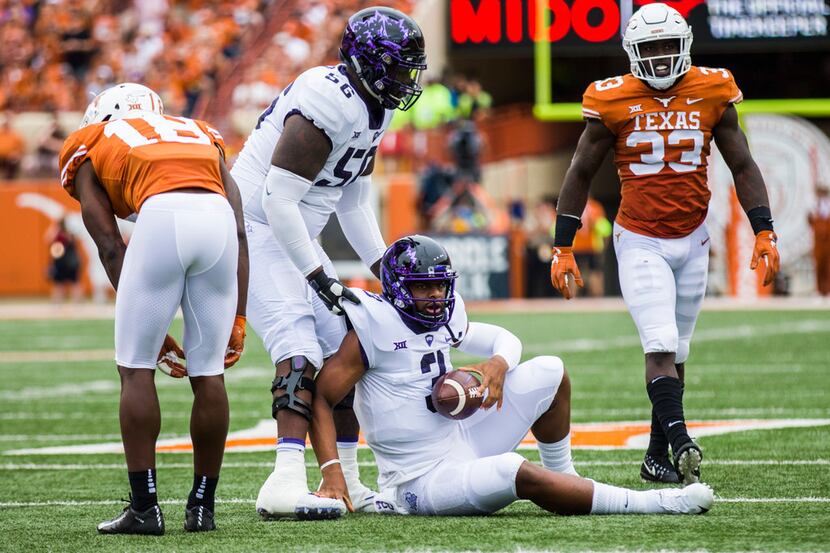 TCU Horned Frogs quarterback Shawn Robinson (3) is helped up by offensive tackle Austin...
