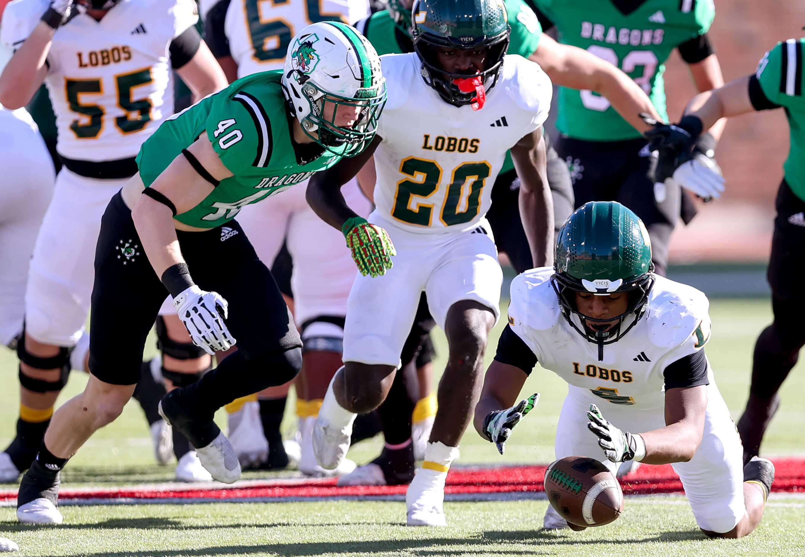 Longview running back Buster Mumphrey (4) recovers a fumble in front of Southlake Carroll...