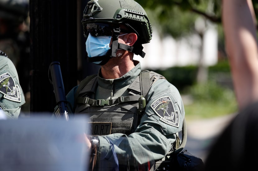 A officer from the Bureau of Prisons special operations response team carries a...