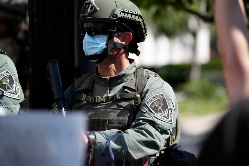 A officer from the Bureau of Prisons special operations response team carries a...