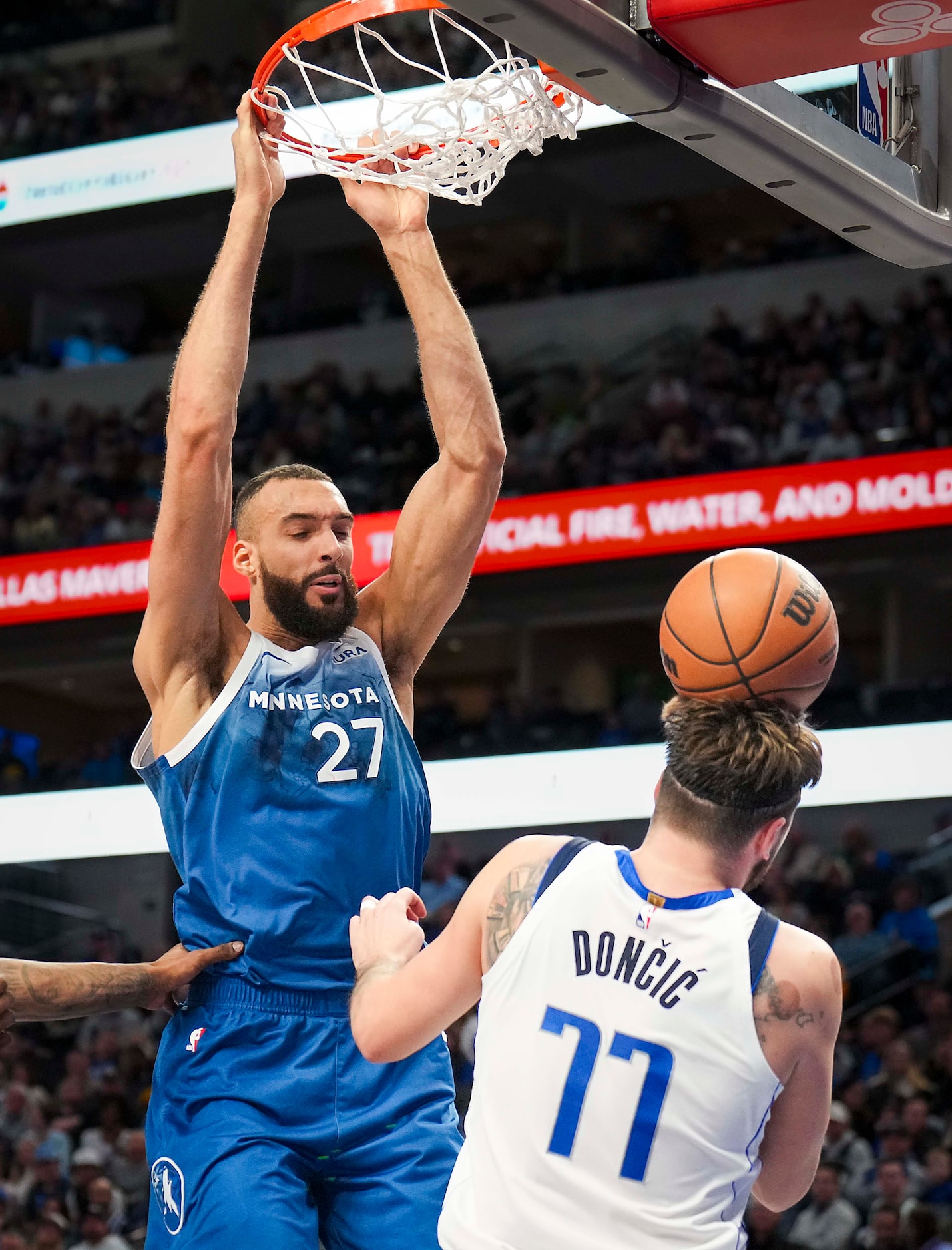 Minnesota Timberwolves center Rudy Gobert (27) dunks the ball over Dallas Mavericks guard...