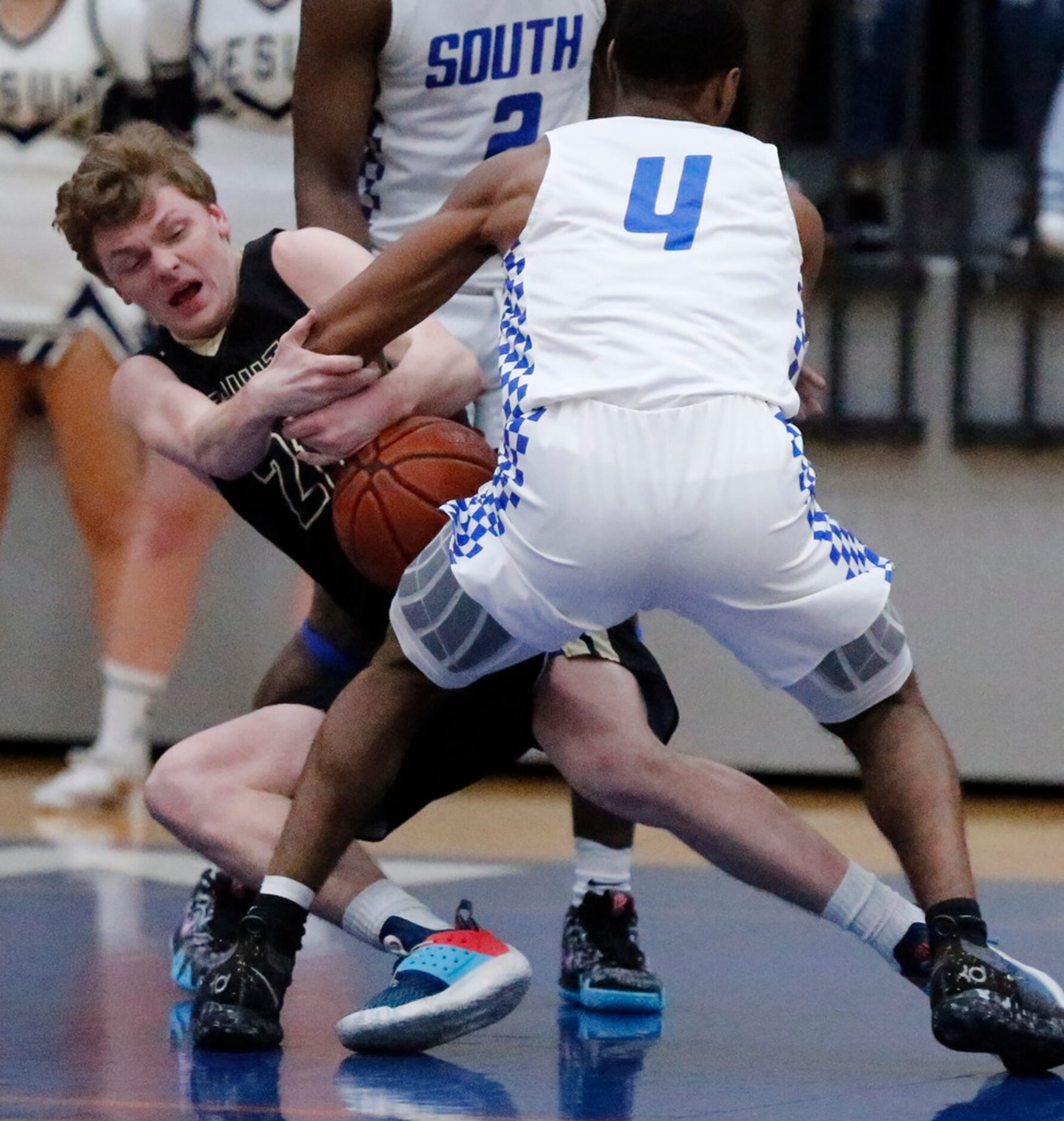 Dallas Jesuit guard Anthony Hollerich (21) loses the ball as he is defended by South Garland...