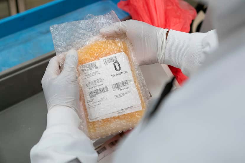 A lab technician freeze packs convalescent plasma donated by recovered COVID-19 patients in...