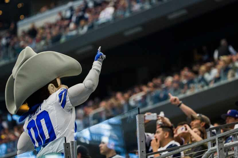 The Dallas Cowboys mascot, Rowdy, fires up the crowd during the second quarter of their game...