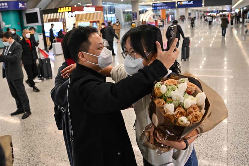 A passenger receives a hug while leaving the arrival area of international flights at the...