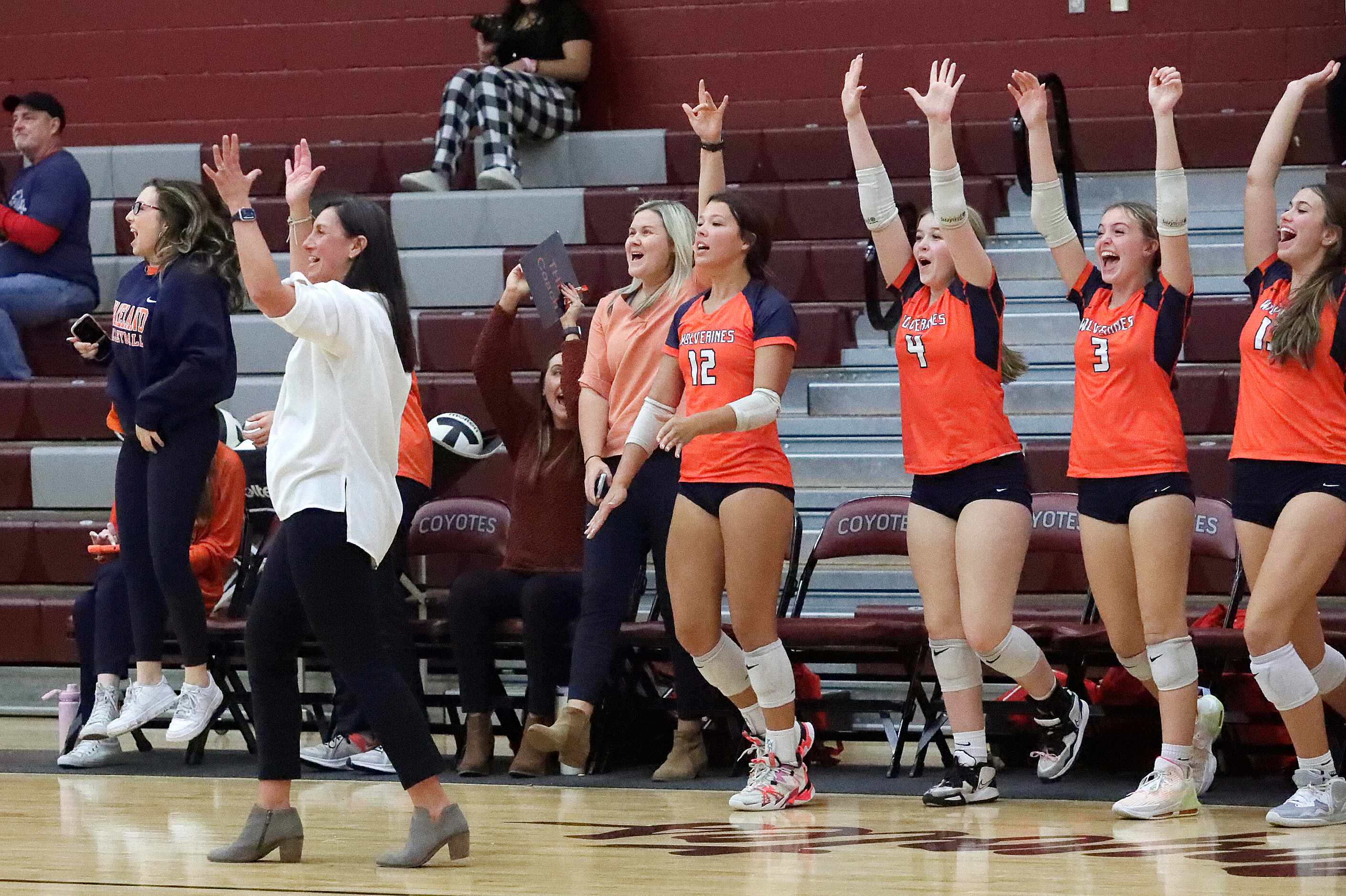 Wakeland High School head coach U'iLani Womble and the Wakeland High School bench react to...