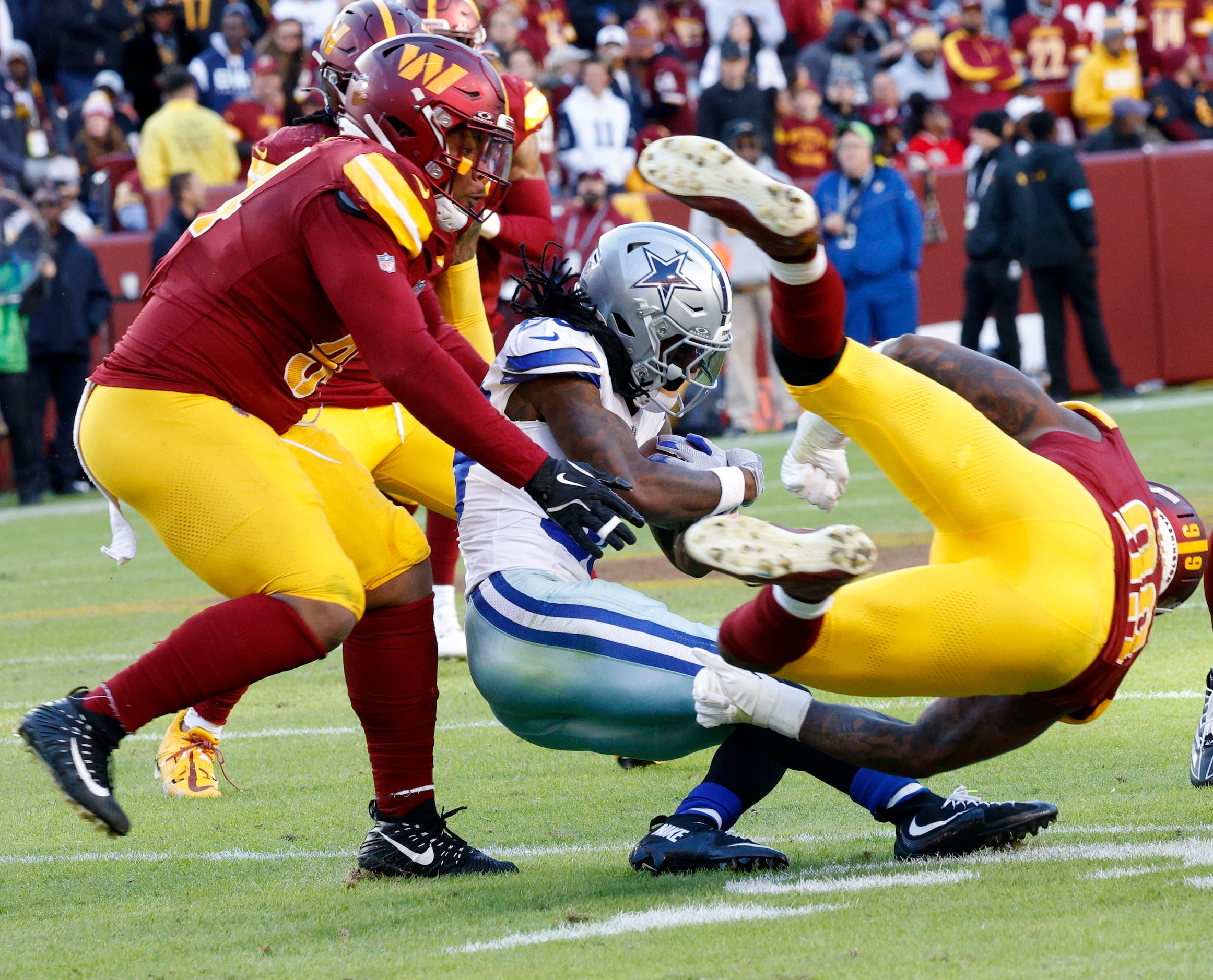 Dallas Cowboys wide receiver CeeDee Lamb (88) is tackled by Washington Commanders defensive...