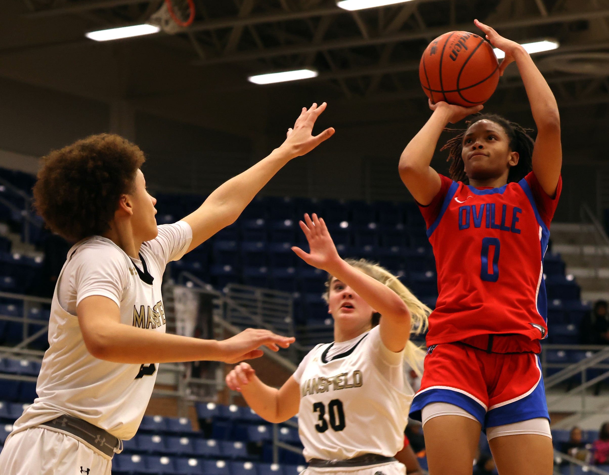 Duncanville guard Chloe Mann (0) gets off a jump shot as she is defended by Mansfield guard...