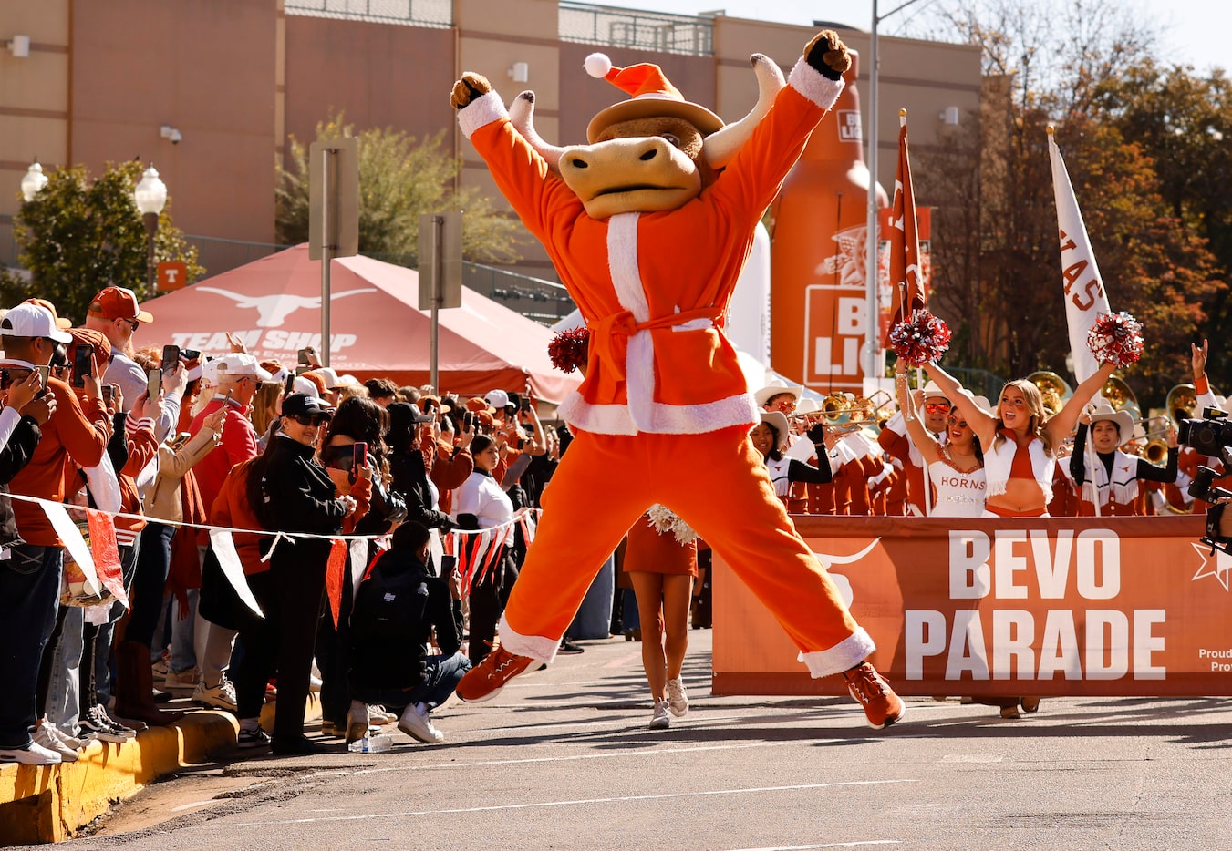 Dressed in Christmas holiday cheer, Hook 'Em jumps for joy as the Longhorn Band arrives for...