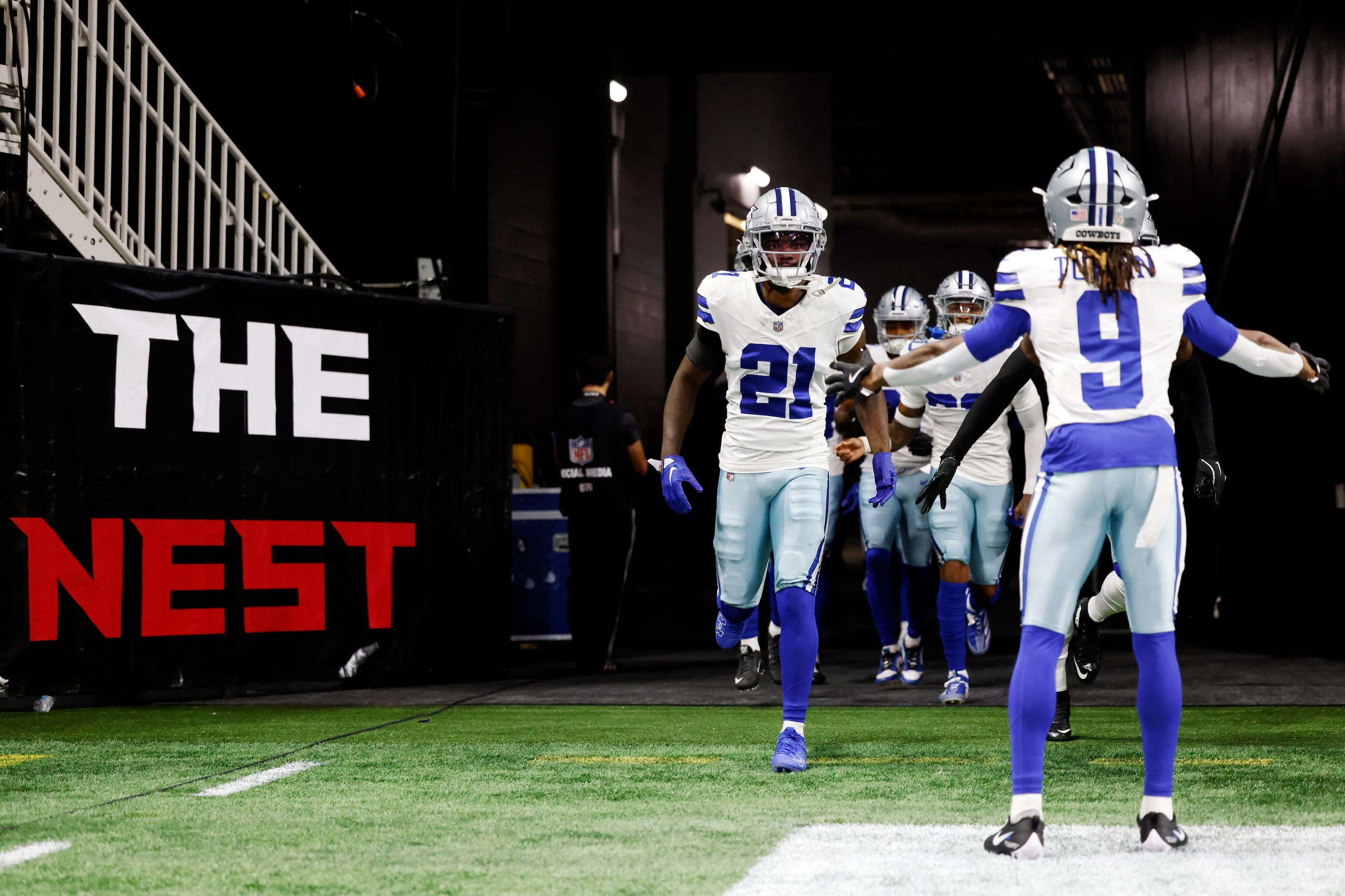 Dallas Cowboys wide receiver KaVontae Turpin (9) high-fives teammates as they take the field...