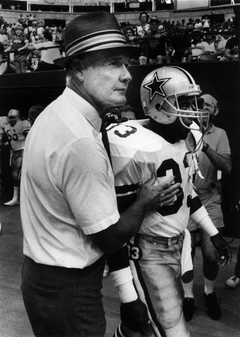 Cowboys coach Tom Landry with Tony Dorsett at player introduction at beginning of game.