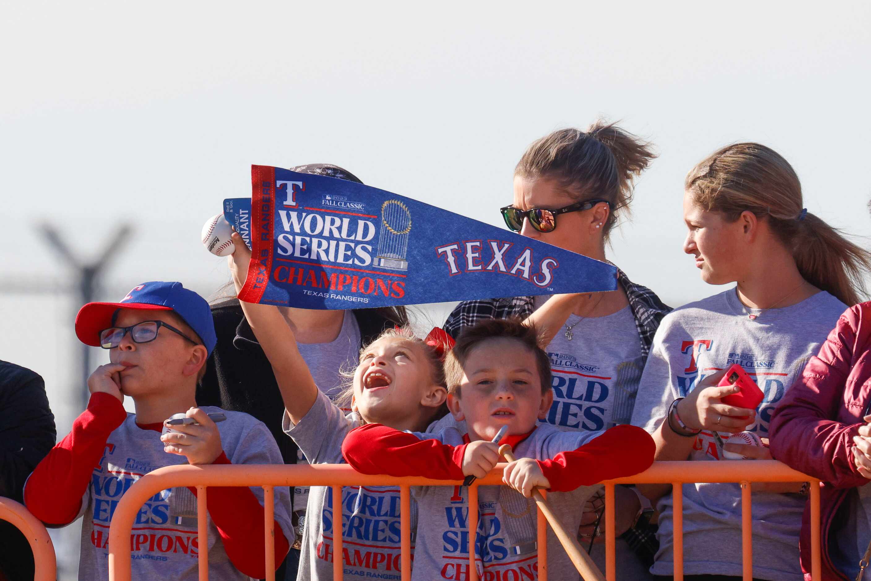 Fans cheers as Texas Rangers arrive at Dallas Love Field following their first-ever World...