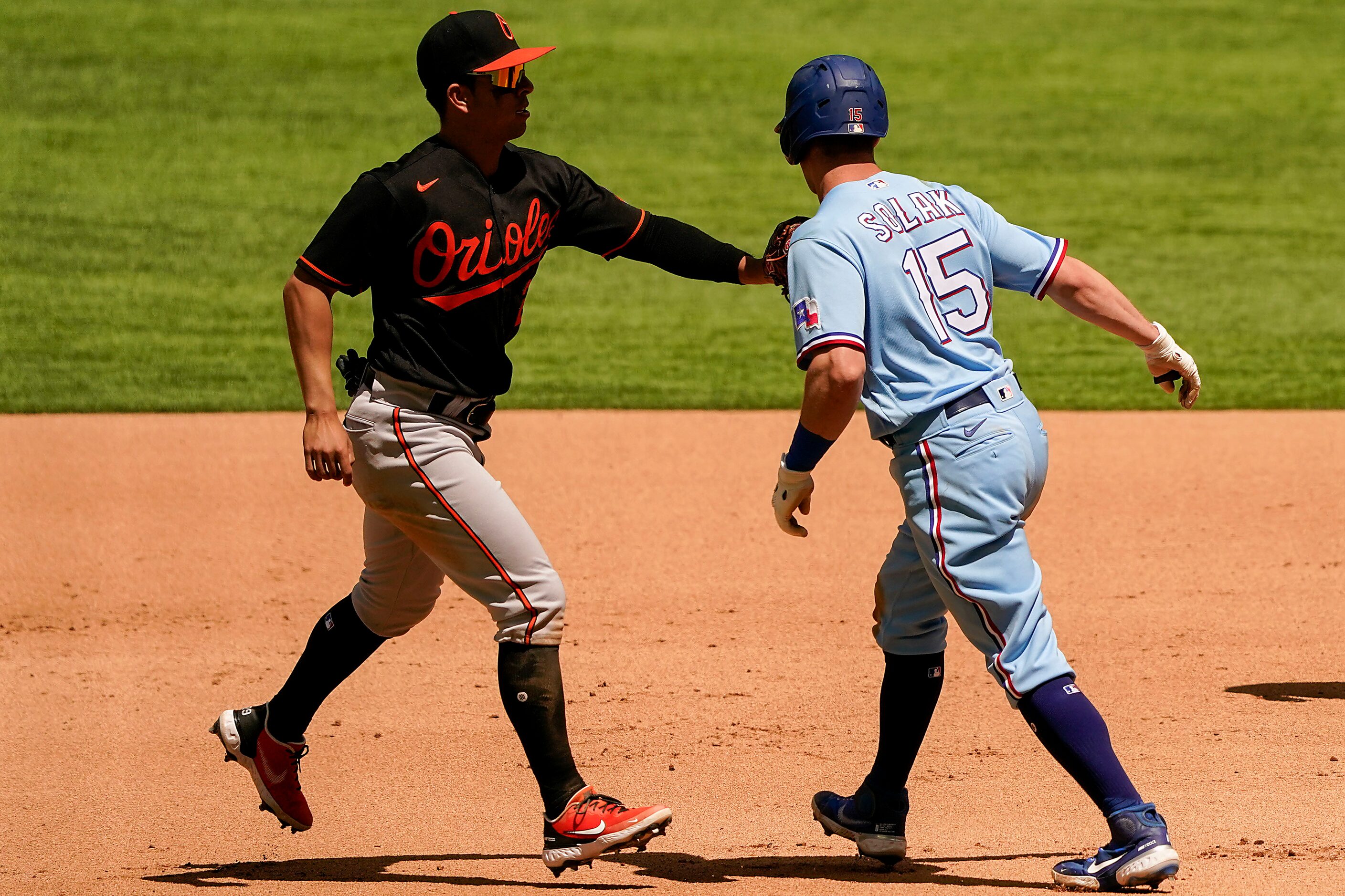 Baltimore Orioles second baseman Ramon Urias puts a tag on Texas Rangers second baseman Nick...