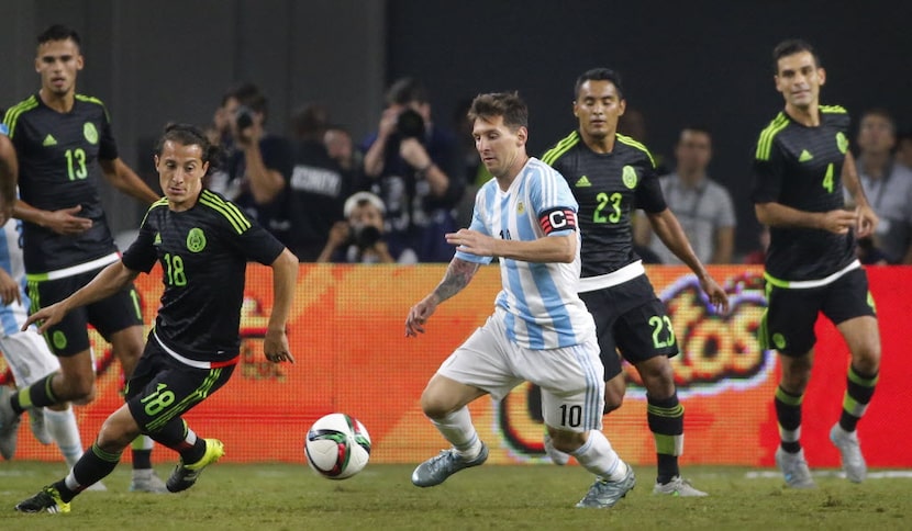 Argentina's Lionel Messi (10) is surrounded by the Mexico defense during the second half...