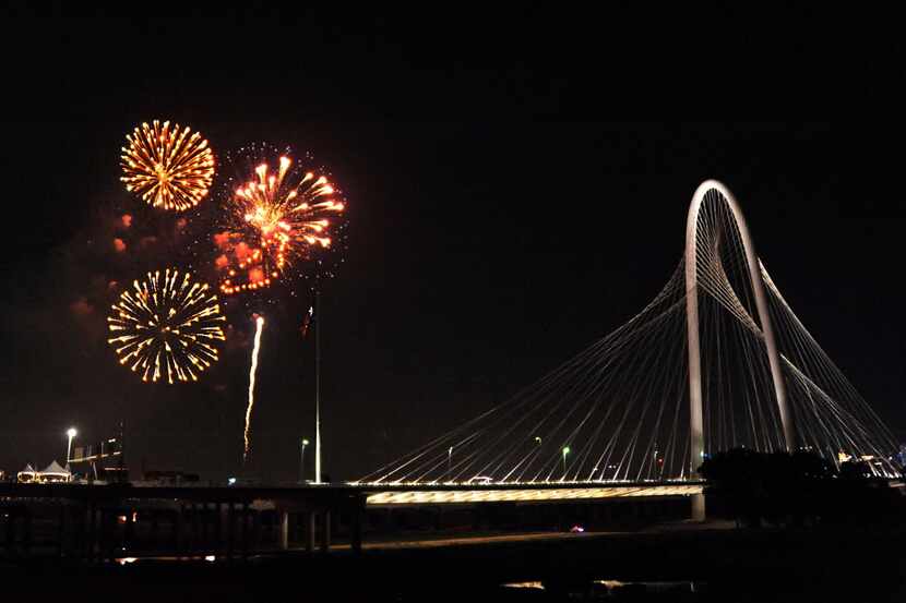 Fireworks light up the sky over the Margaret Hunt Hill Bridge at Red, White, and Boom on the...