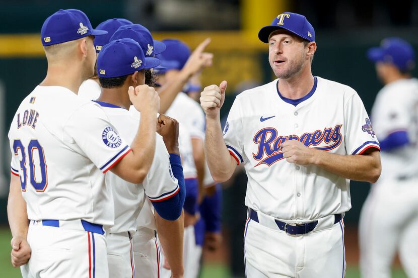 Texas Rangers starting pitcher Max Scherzer greets teammates before the season opener at...