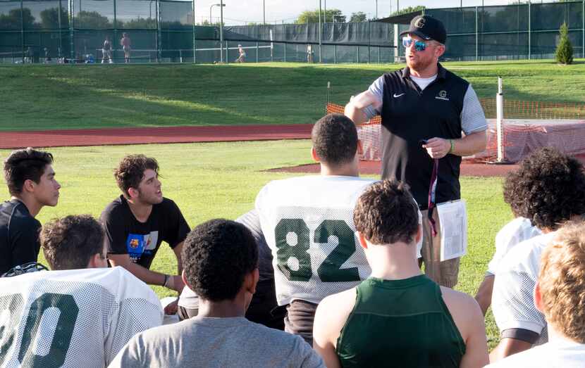 Head coach Casey Selfridge speaks to the team after a Wednesday practice as senior lineman...