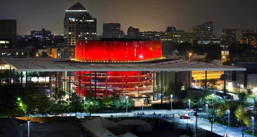 The distinctive red drum of the Margot and Bill Winspear Opera House glowed in the night as...