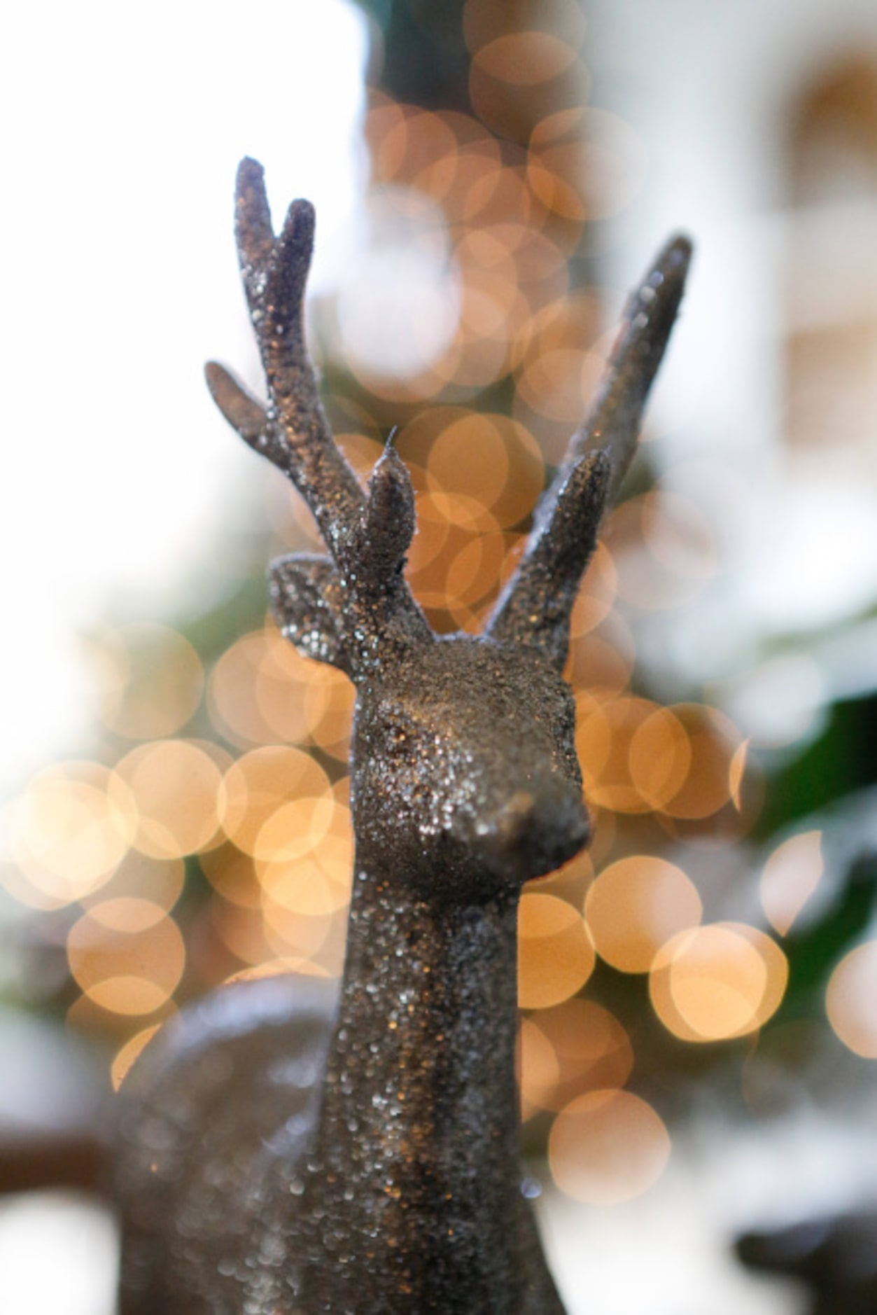 Glittered deer find homes on tabletop vignettes throughout the living room.