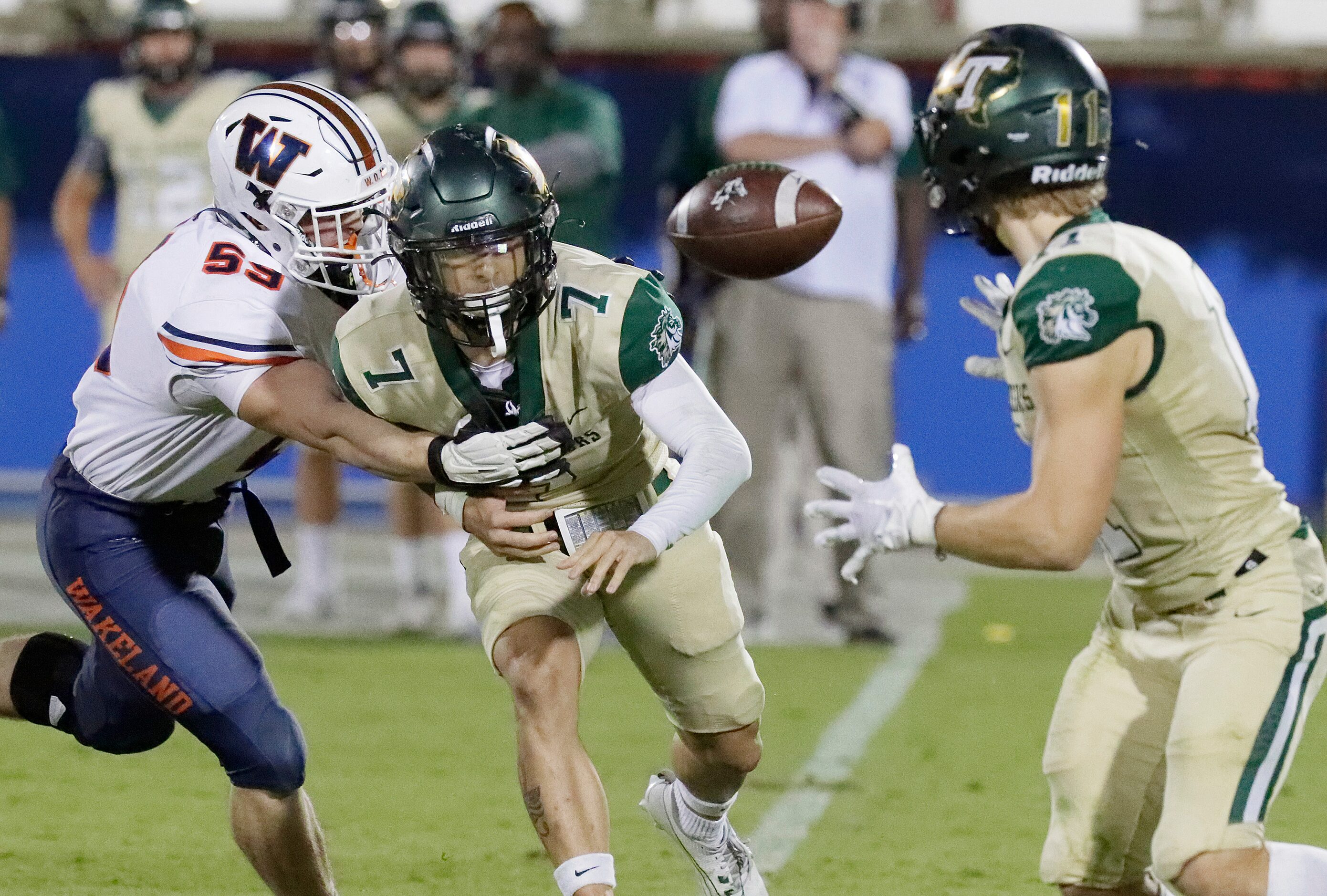 Wakealnd High School defensive end Austin Wilson (59) forces Lebanon Trail High School...