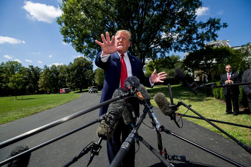 President Donald Trump speaks with reporters before departing on Marine One on the South...