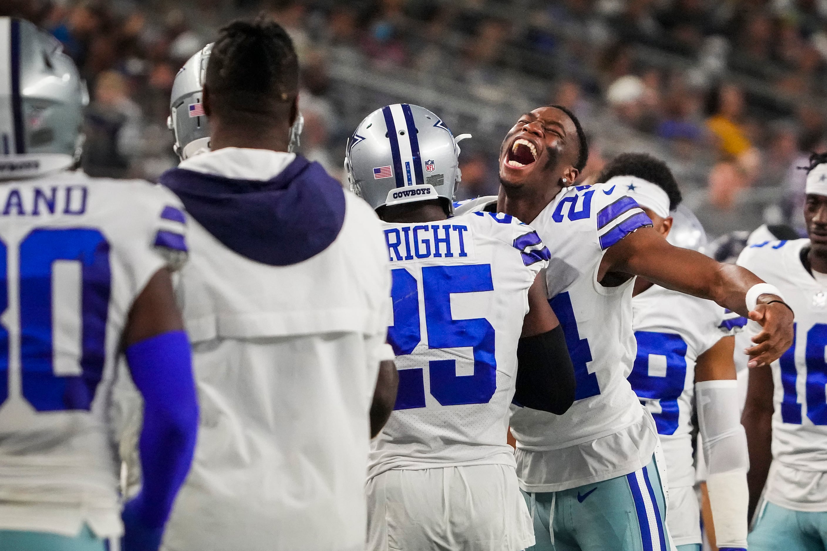 Dallas Cowboys cornerback Nahshon Wright, left, intercepts a pass