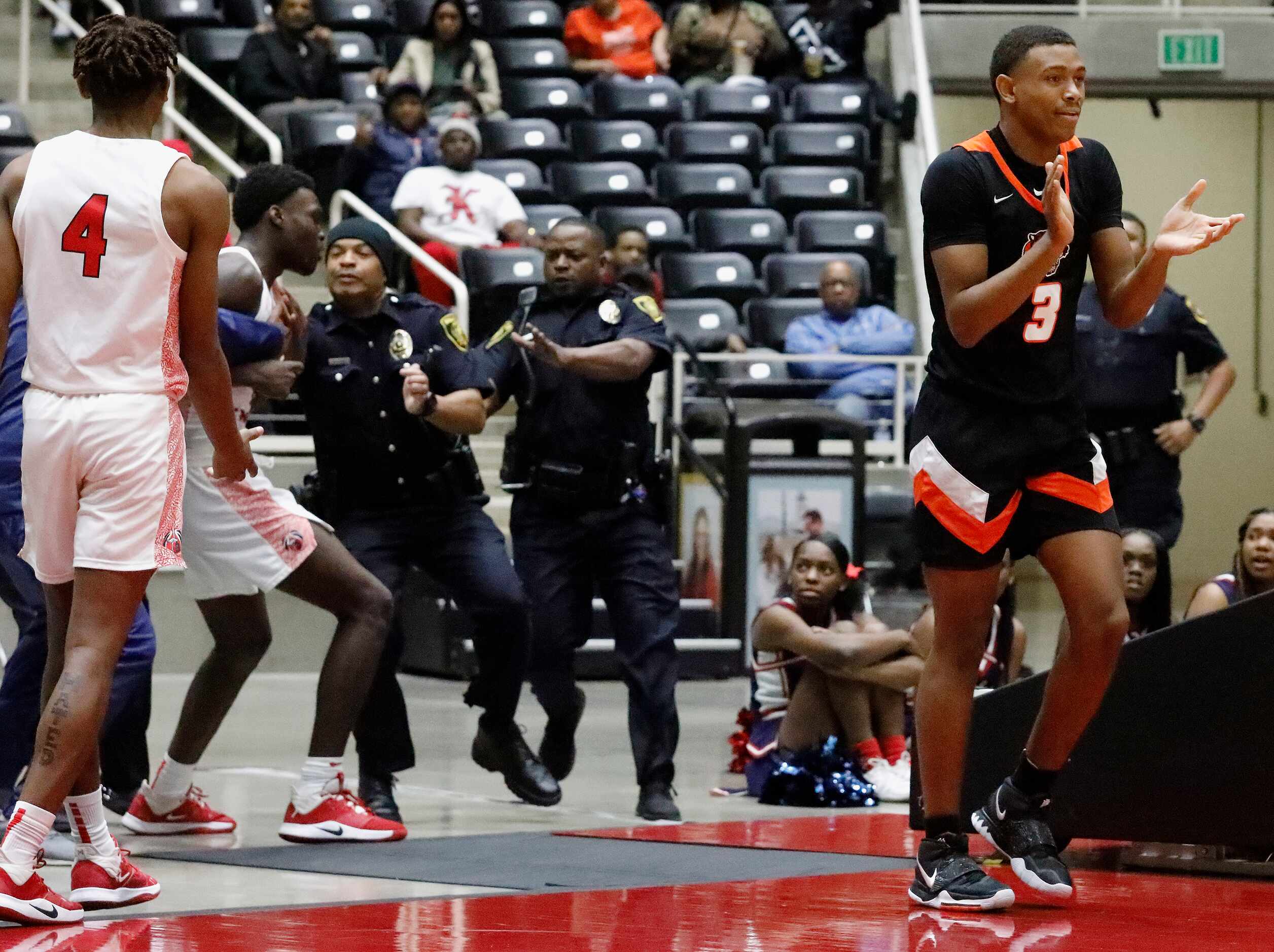 Kimball High School forward Kyron Henderson (15) is restrained by officials and police after...