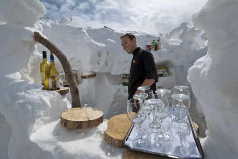 A bartender is ready to pour drinks at Aspen Highland's Cloud Nine on-mountain restaurant,...
