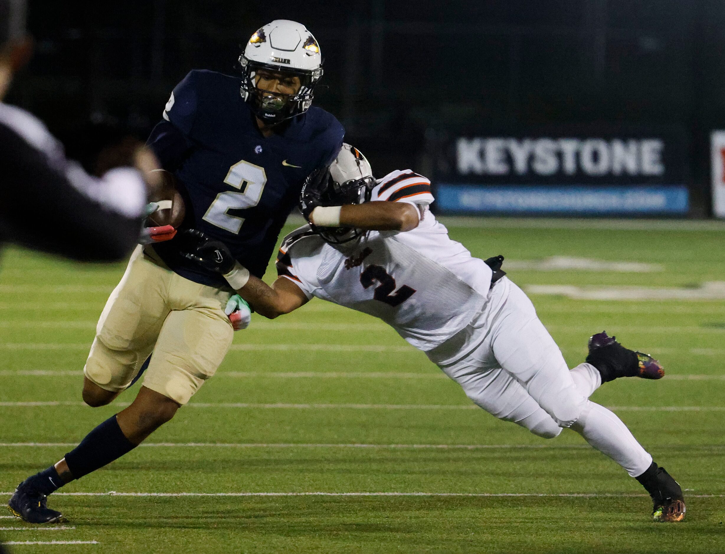 Keller High’s Tre’ Griffiths (left) gets tackled by Haltom high’s Tyus Davis during the...