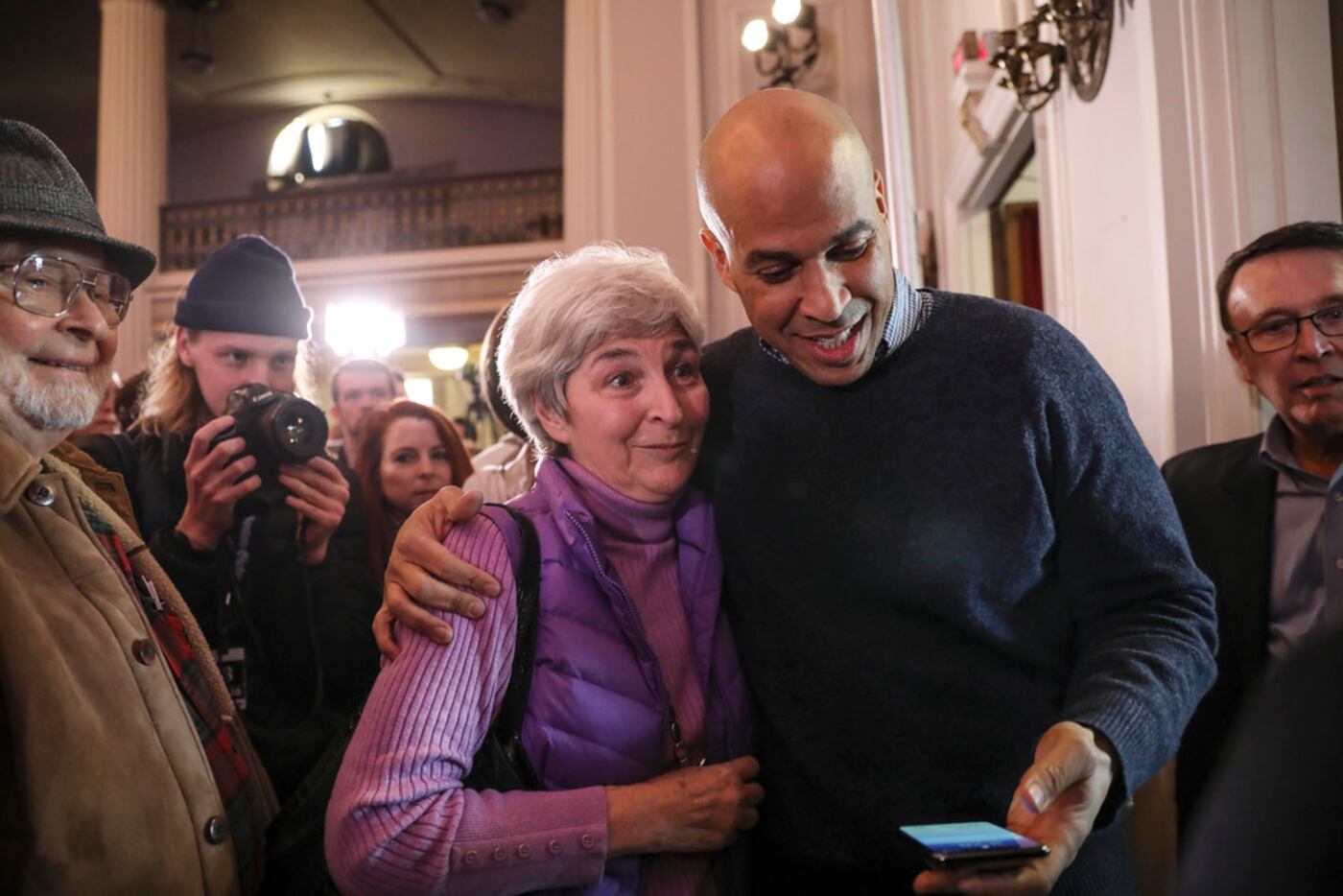 Sen. Cory Booker, D-N.J., prepares to take a selfie with a supporter at a post-midterm...