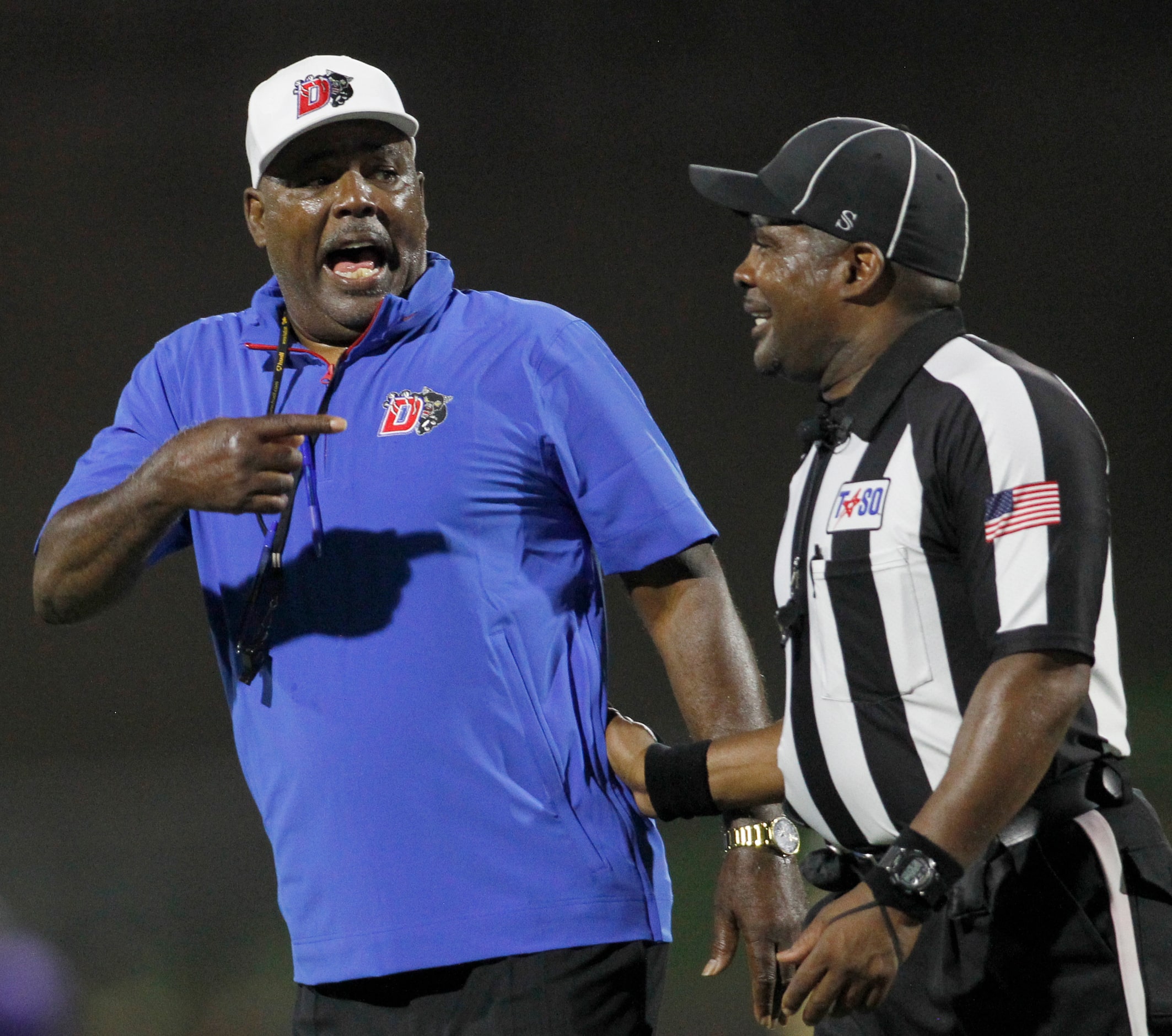 Duncanville head coach Reginald Samples delivers a spirited message to a game official...