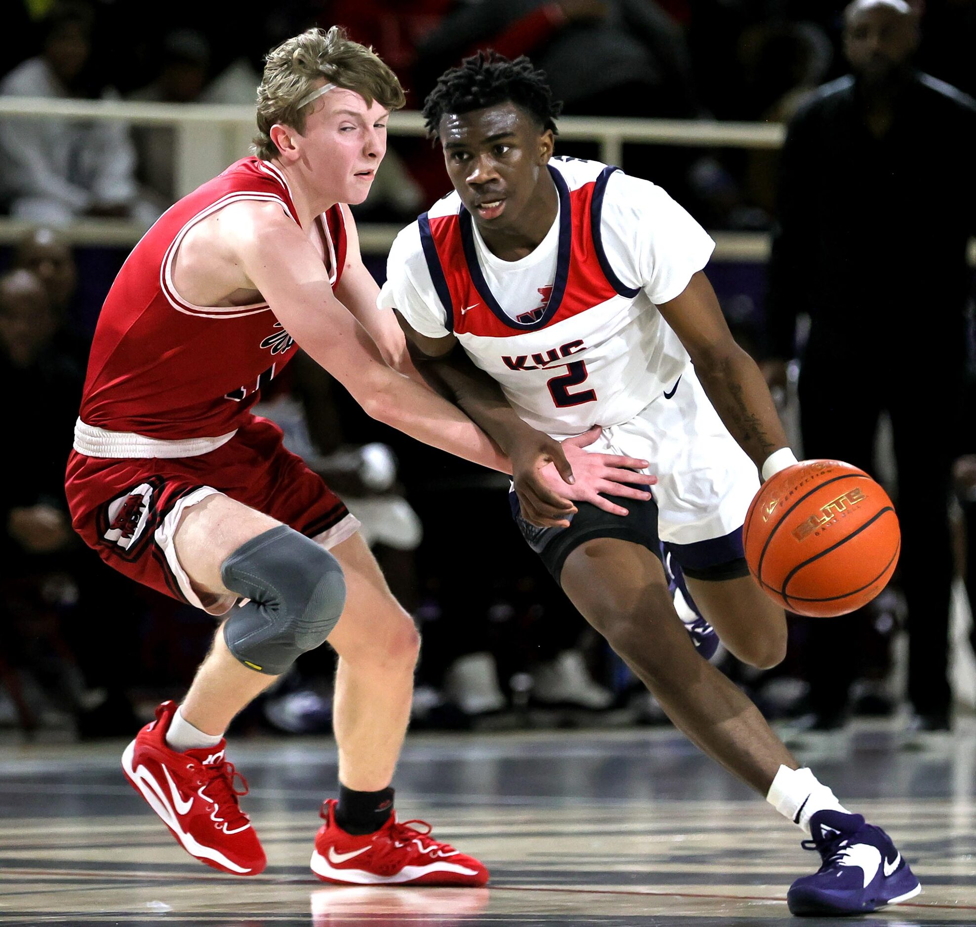 Kimball guard T'Johnn Brown (2) looks to drive to the basket against Woodrow Wilson guard...