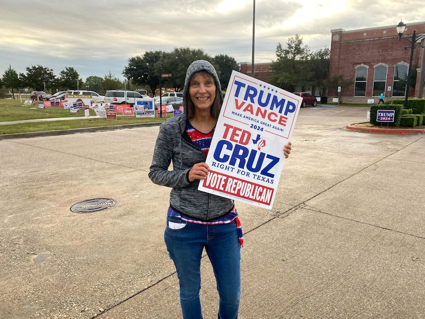 Sylvia Coulson, 67, poses with a sign supporting Donald Trump and Ted Cruz outside Red Oak...