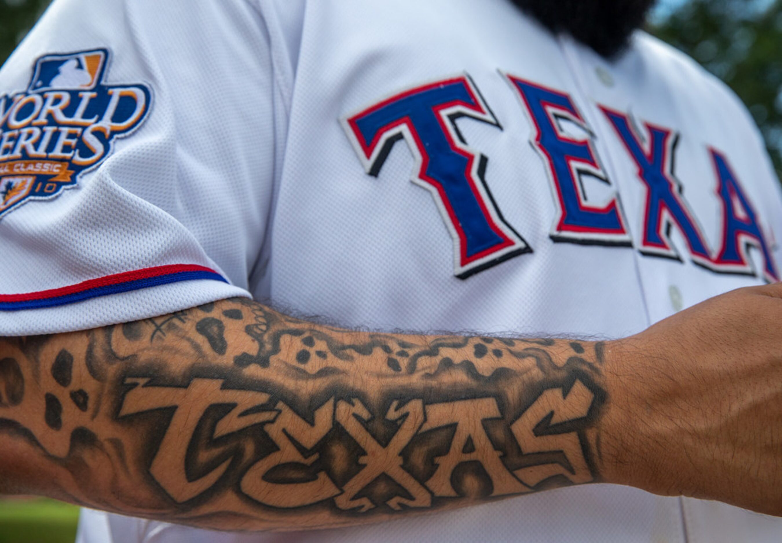 Yoel Carranco, from Dallas, waits to cross the street into Globe Life Park for the Rangers'...