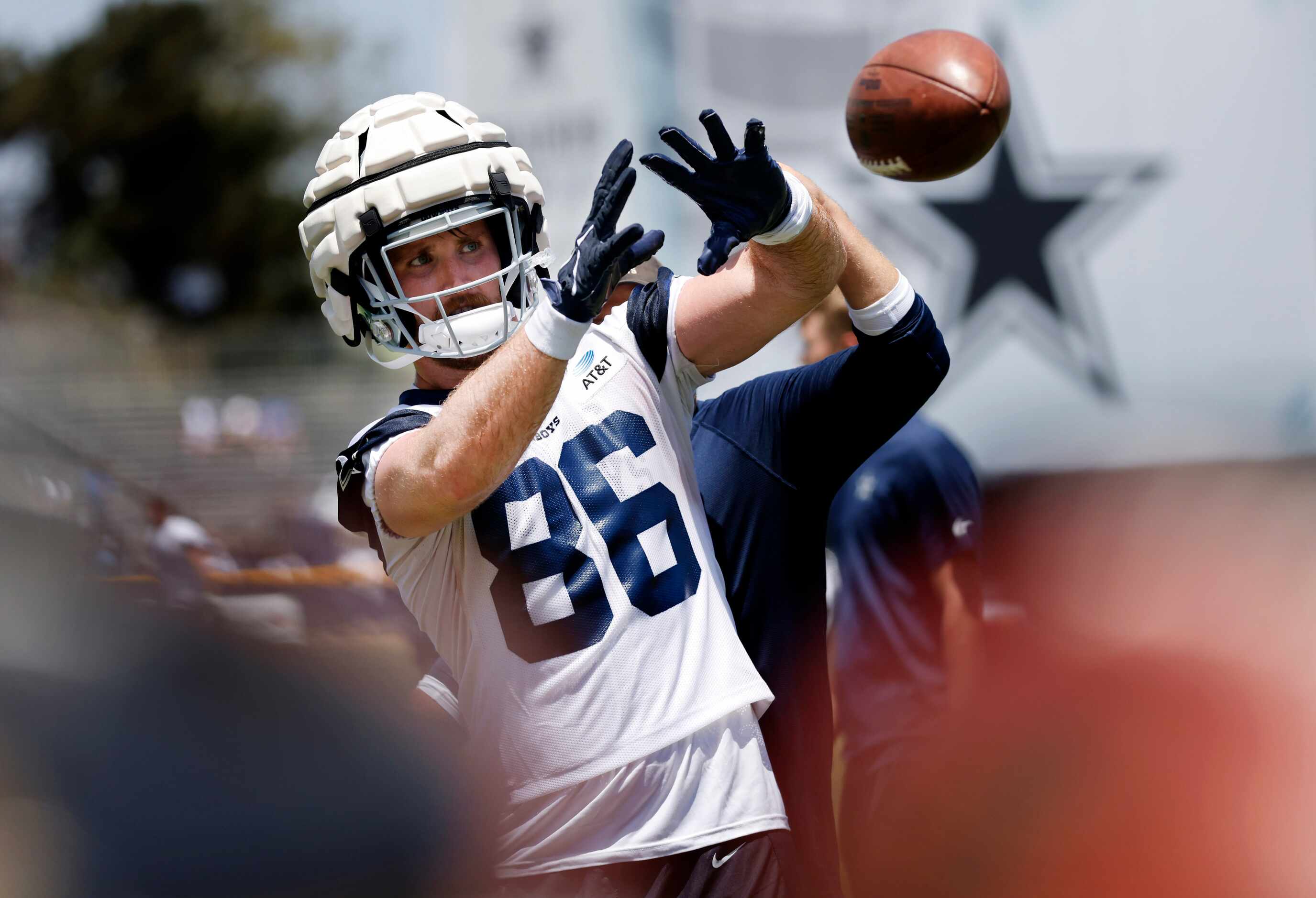 Dallas Cowboys tight end Dalton Schultz (86) works on his catching skills in front of a...
